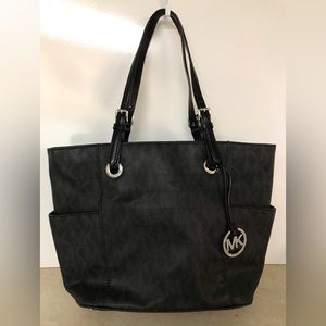Michael Kors black faux leather fully lined tote.